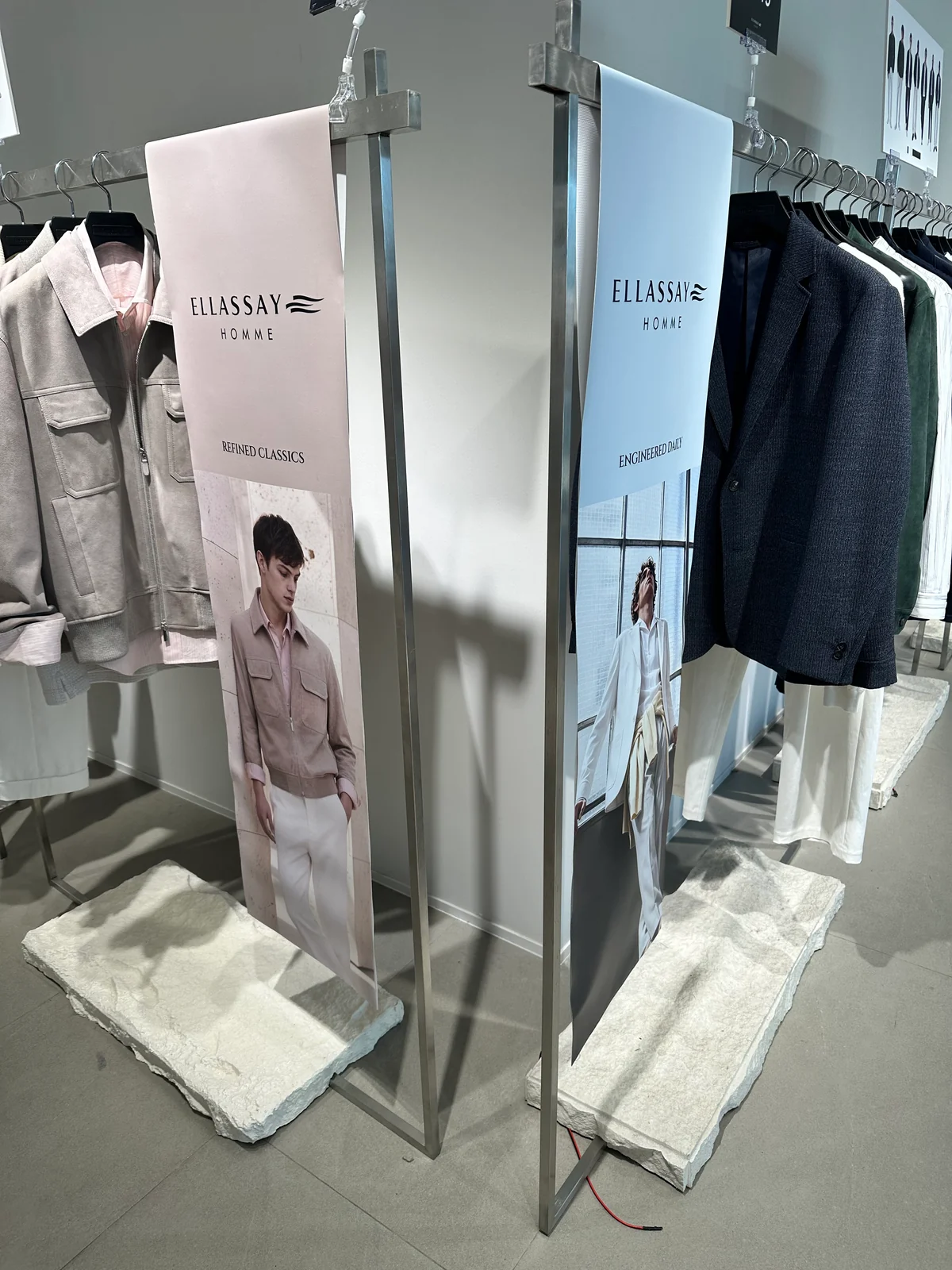 Fashion presentation with clothing rails and mirrored display plinths