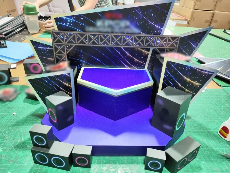 Stage-themed showcase scene with printed backdrop and platform